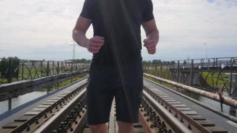 Close up of muscular man running over the bridge Video stock 84004417