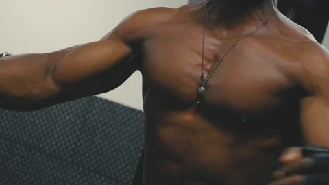 Close up of muscular pectoral muscles using cable crossover machine at the gym Stock Footage 89577335