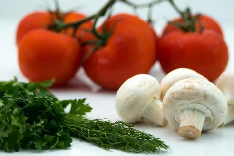 Close up of mushrooms, herbs and tomatoes Stock Photos