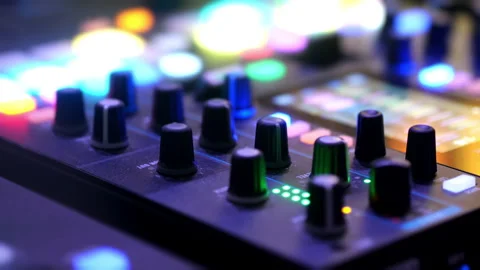 Close-up of a music controller in action at an event in color light. Stock Footage 314343149