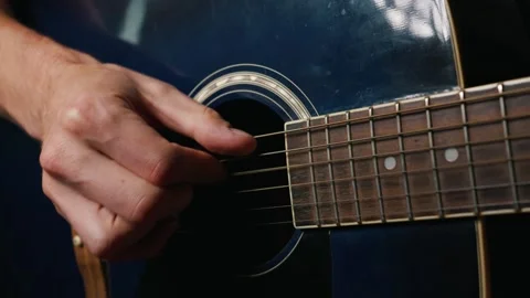 Close Up of Musician Hands Plucking Strings on Blue Acoustic Guitar Stock Footage 339366914