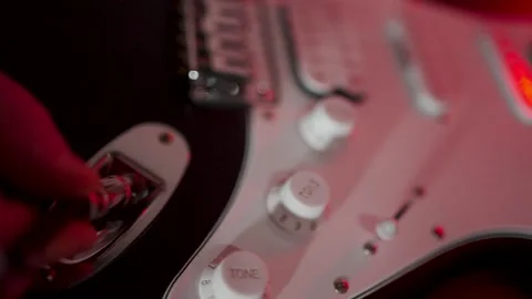 Close-up of Musician Plugging Jack Cable into Electric Guitar. A musician h.. Stock Footage 332287990
