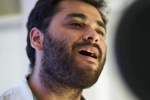 Close-up of musician singing softly in front of the microphone 스톡 사진