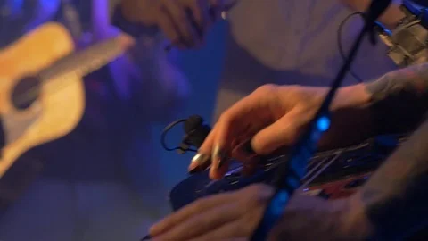 Close-up of musician's hands playing lap-top guitar at a concert. Stock Footage 109144665