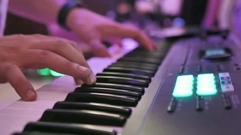 Close-up of a musician's hands playing a synthesizer, a keyboard instrument. A Stock Footage 295798480