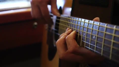 Close-up of a musician's hands playing various notes on an electro-acoustic Stock Footage 164618664