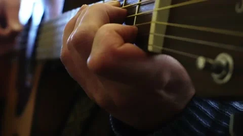 Close-up of a musician's hands playing various notes on an electro-acoustic 库存影片 164618836