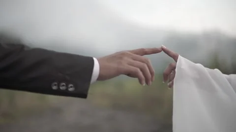 Close up of a Muslim couple's finger touching with Merapi mountain background Stock Footage 248941367