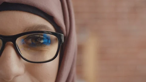 Close-up of a Muslim woman's face looking into the camera and smiling. Happy Stock Footage 123720543