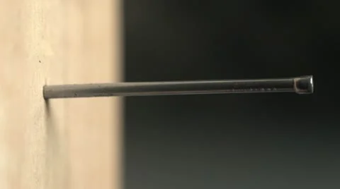 Close up of a nail being hammered into wood Stock Footage