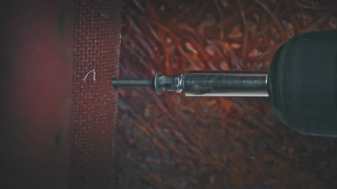 Close-up of a Nail Being Tightened with a Screwdriver in Slow Motion Stock Footage 252655562