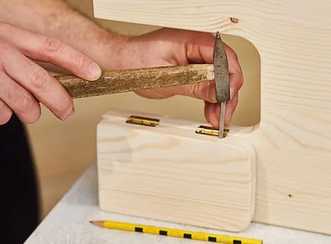 Close-up of nail hammering hands. Stock Photos