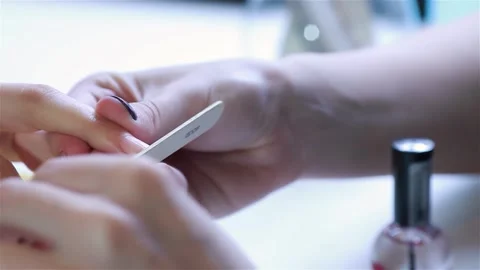 Close-up of a nail polish application with a nail file Stock Footage 311543712