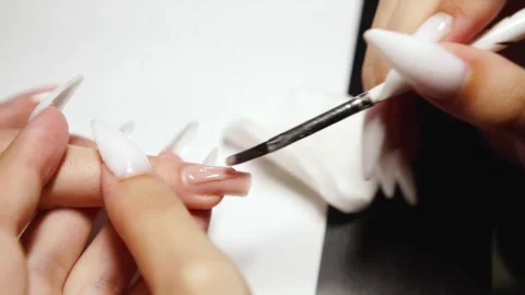 Close-Up of Nail Technician Applying Gel Polish for Extension Stock Footage 317510499