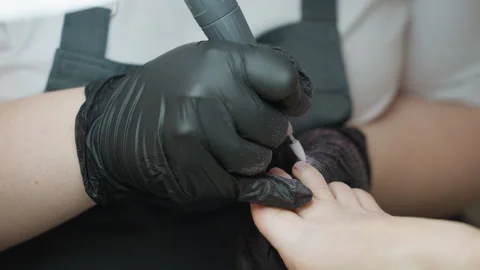 Close Up Nail Technician Switching Toe While Using Electric File Stock Footage 310277045
