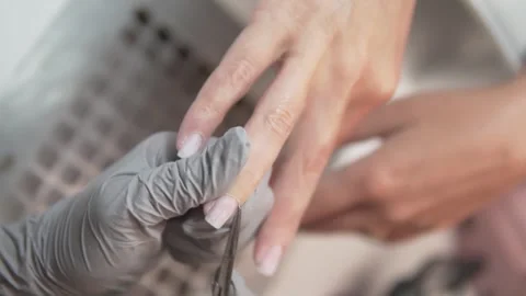 Close-up of a nail technician using an electric drill to clean the cuticle area Stock Footage 311872668