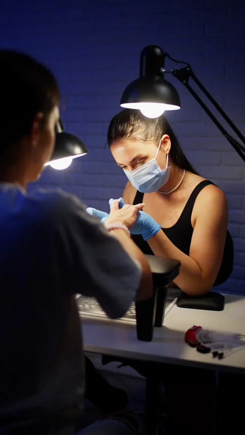 Close up of nail technician using electric nail drill to prepare female nails Video stock 343539697