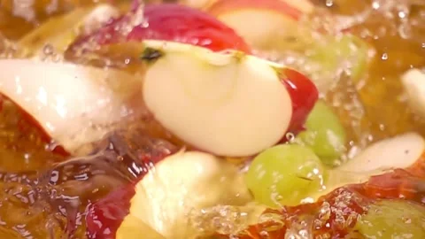 Close up of natural apples, pears quarters and grapes falling in juice, adv.. Stock Footage 305784964