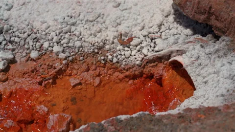 Close up of natural orange saline spring water feeding the salt evaporation Stock Footage 345005122