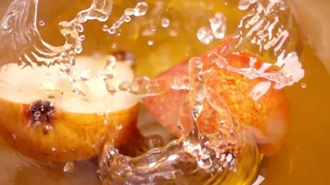 Close up of natural pears halves falling in juice, advertising of fruit jui.. Stock Footage 305785009