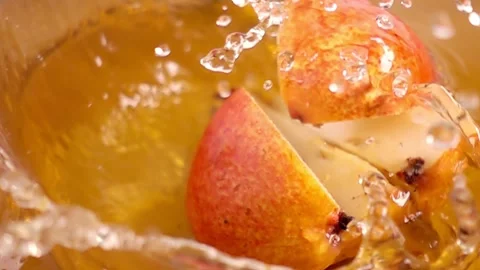 Close up of natural pears quarters falling in juice, advertising of fruit j.. Stock Footage 305785065