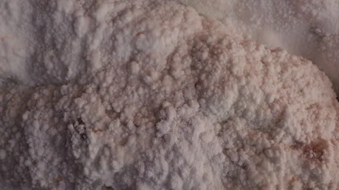 Close-up of natural pink salt formations inside a salt cave, showing mineral Stock Footage 328360880