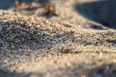 Close-up of natural sand patterns creating soft, wave-like textures on a beac Stock Photos