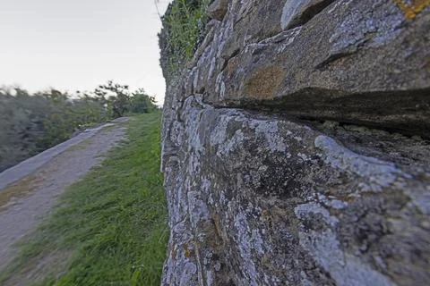 Close-up of a natural stone wall with sharpness in the center of the image .. Stock Photos