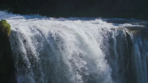 Close up of a natural waterfall with fresh river water flowing in a forest. Stock Footage 157615058