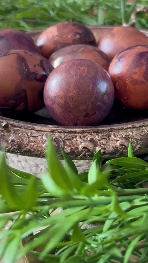 Close-up of naturally colored Easter eggs in an ornate vintage bowl, partially Stock Footage 336213288