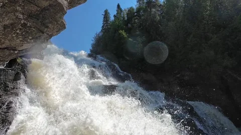 Close-up nature scene of foaming waterfall water cascading over rugged rocks Stock Footage 341706537