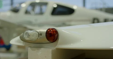 Close up of navigation light on white airplane wing tip Stockbeeldmateriaal 329551464