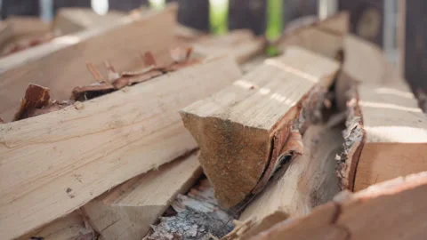Close up of neatly stacked split logs on paved ground with soft blur background Stock Footage 316838397