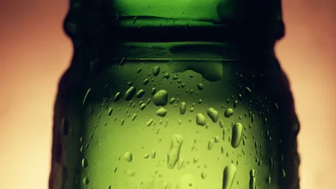 Close-up - neck of green bottle with many bubbles on gray background Stock Footage 144667003