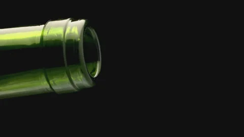 Close-up of the neck of a wine bottle from which pink wine is poured. Wine pours Stock Footage 132931058