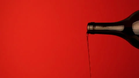 Close up of the neck of a wine bottle from which pink wine is poured. Stock Footage 142520463