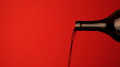 Close up of the neck of a wine bottle from which red wine is poured. Stock Footage 142521461