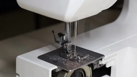 Close-up of needle and presser foot mechanism of modern white sewing machine Stock Footage 329621653