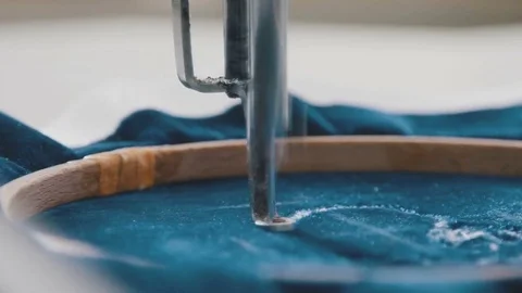 Close-up: needle moves quickly, embroidering a pattern on the fabric Video stock 74101133