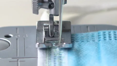 Close up of needle on sewing machine moving left right and sewing covdi-19 mask Stock Footage 137550325