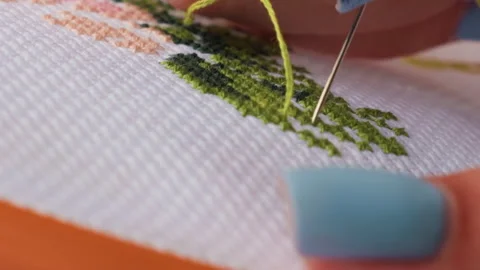 Close Up Needle Stitching Green Thread on Cross Stitch Fabric Stock Footage 330599884
