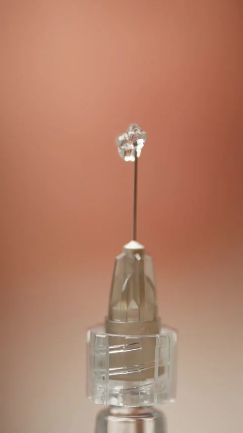 Close-up of the needle of the syringe from which the liquid comes out. Stock Footage 294707702