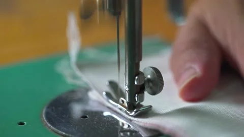 Close-up of needles on a vintage sewing machine sewing cloth Stock Footage 219597798