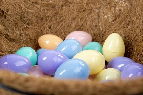 Close up nest of plastic shiny easter eggs side view Stock Photos