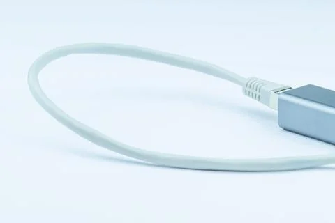 Close-up of a network cable connected to a silver adapter.  Clean, simple t.. Stock Photos