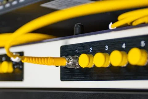 Close up of network switch with yellow ethernet cables connected Foto stock