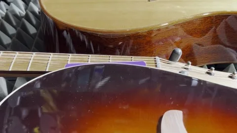 Close-up of new acoustic guitars in the interior of a music store. Vertical Stock Footage 250030285