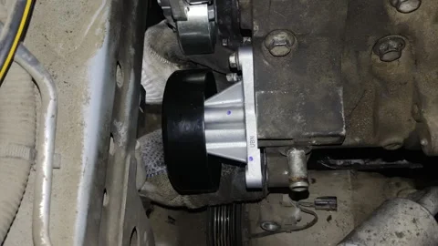 Close-up of a new black pulley installed on car engine Stock Footage 332240380