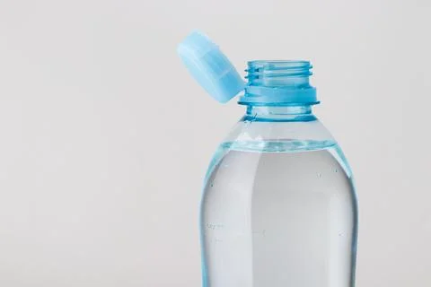 Close up of new cap attached to plastic bottle, connected to the neck of the  Stock Photos