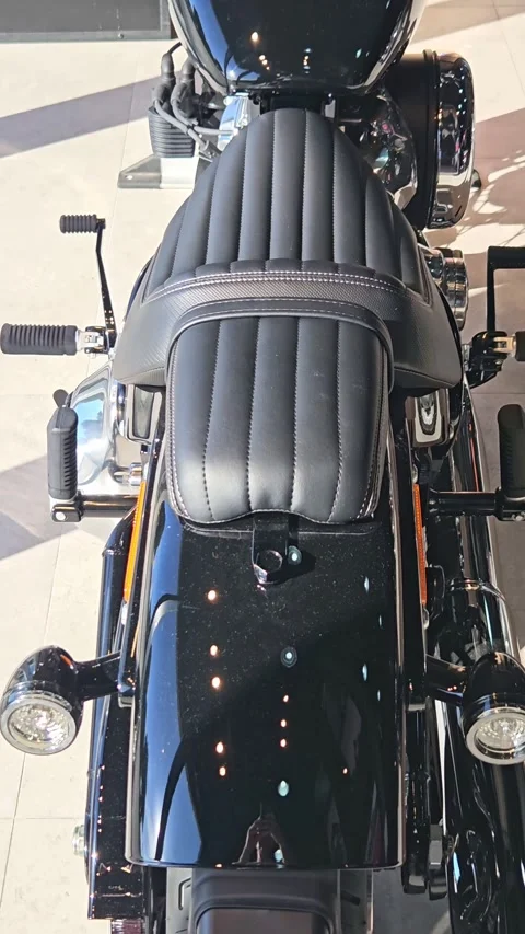 Close-up of new shiny chrome chopper cruiser motorcycle indoor showroom Stock Footage 348156348